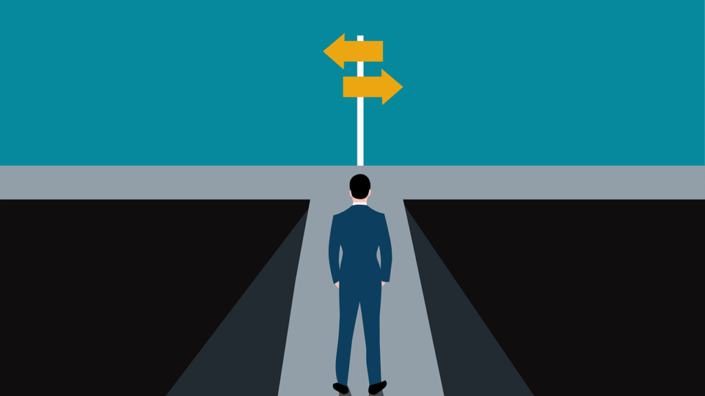 A man stands on a path, choosing between arrows that go in two different directions.