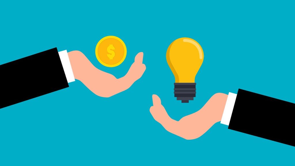 Two hands. One is holding a coin, the other is holding a lightbulb.